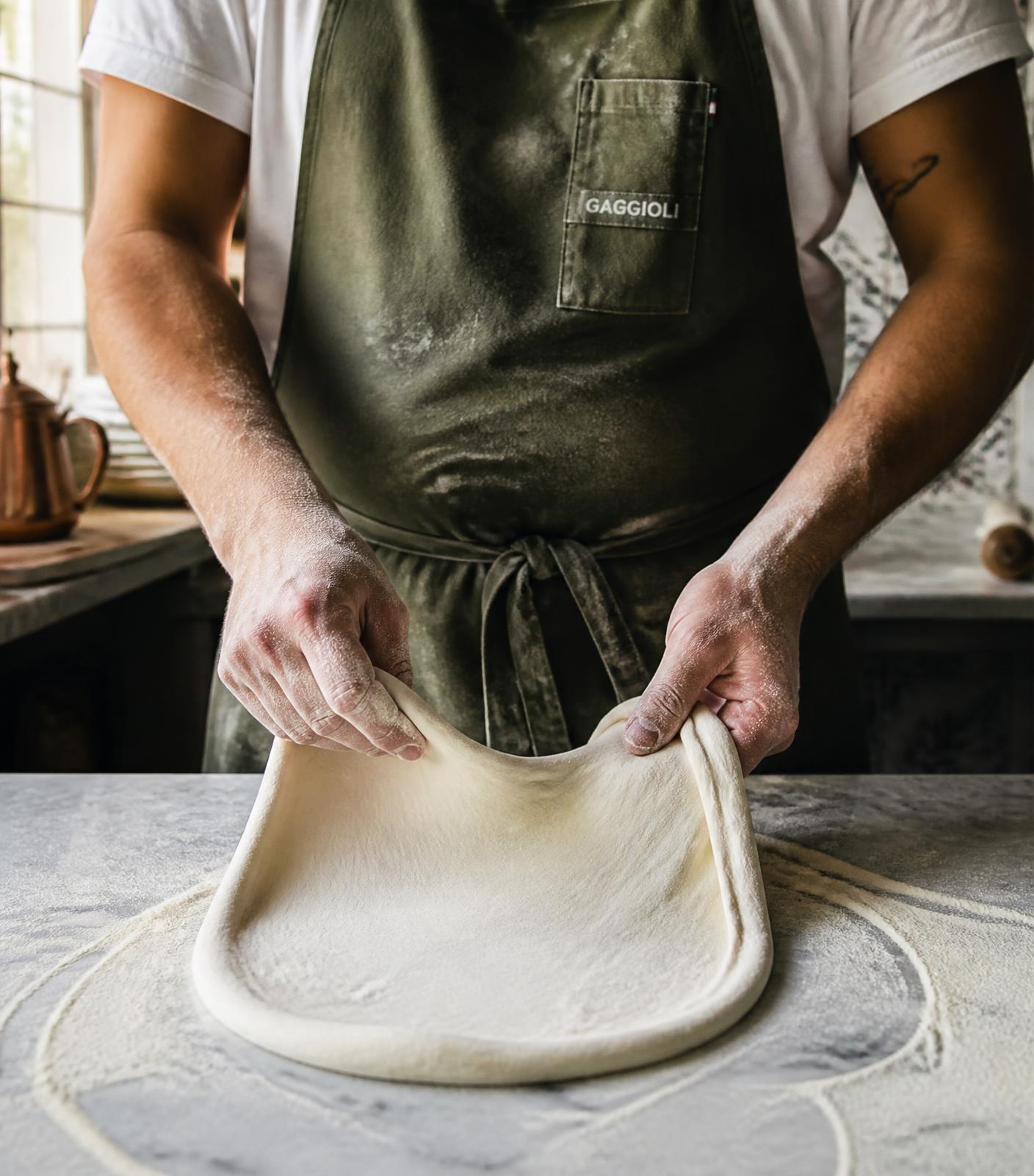 Pizzaiolo abrindo a massa artesanal